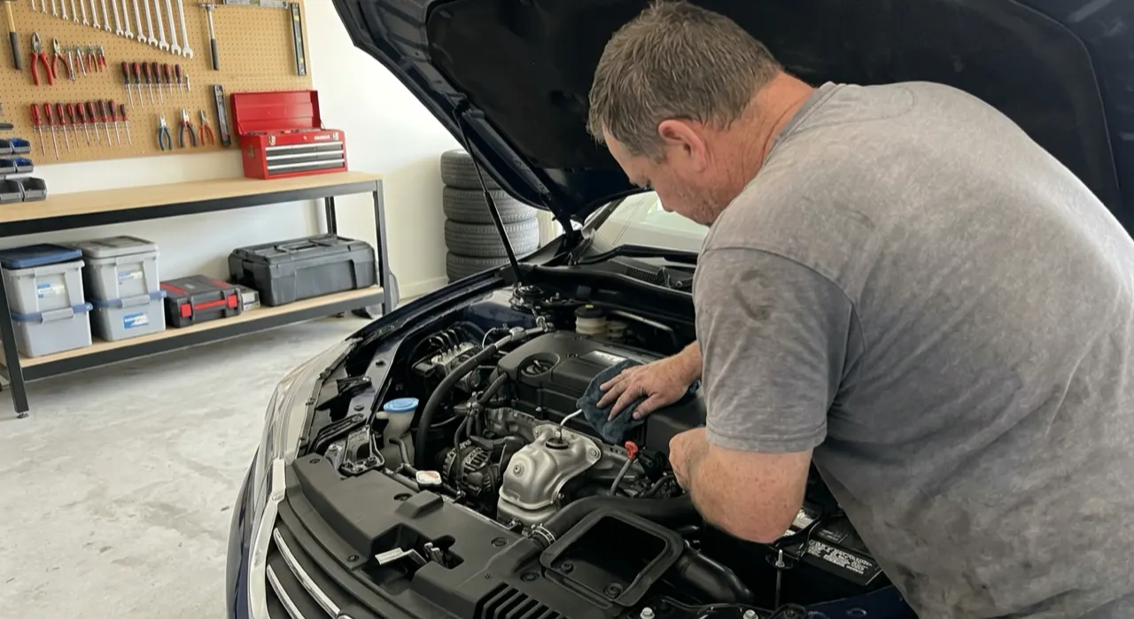 Best Engine Bay Dressing: Satin, Not Greasy — a spotless freshly detailed car engine bay with clean hoses and covers